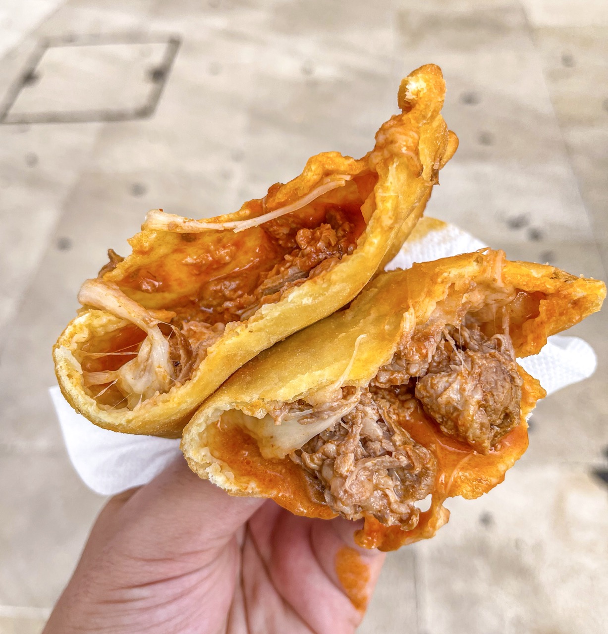 Due panzerotti al ragù di carne con mozzarella filante appena fritti da Panzeropoli Bari